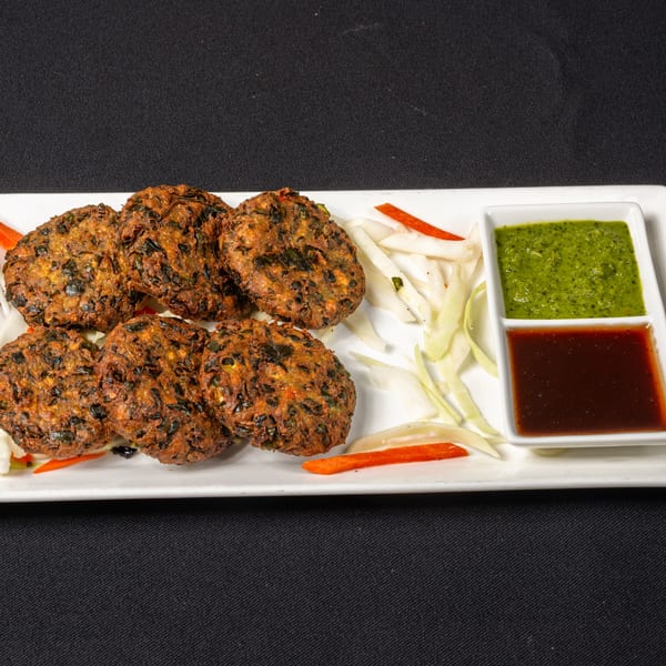 Saffron Indian Cuisine's fried vegetable patties, served with green and brown dipping sauces.